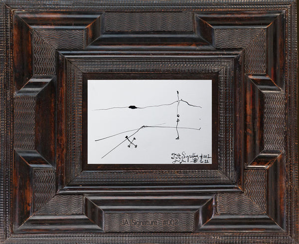 The paper card JA.SIGNATURE N°2 by james arax staged in an ancient frame.
