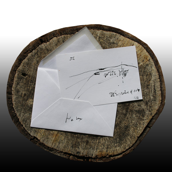 On the log : In the foreground the JA.SIGNATURE N°4  paper card - below the the back side of the James Arax Signature.
