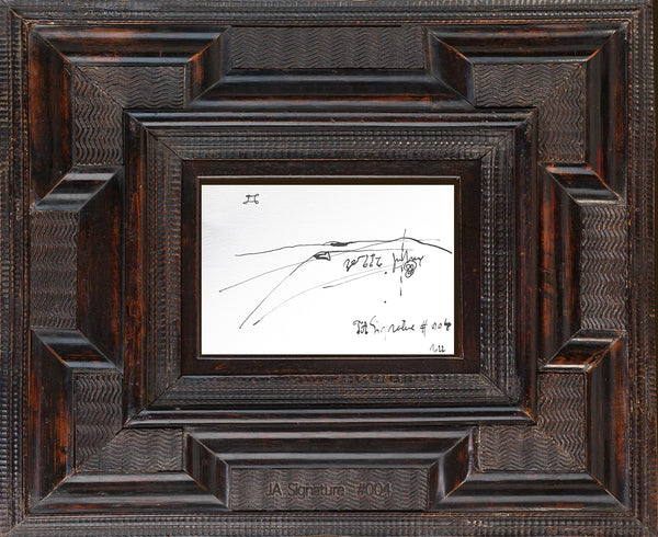 The paper card JA.SIGNATURE N°4 by james arax staged in an ancient frame.