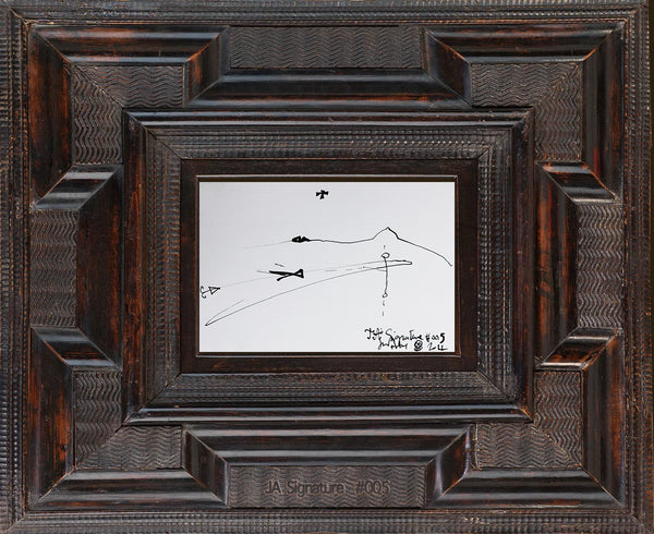 The paper card JA.SIGNATURE N°5 by james arax staged in an ancient frame.